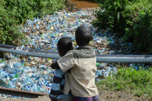 A photo of a two children watching a dumping site