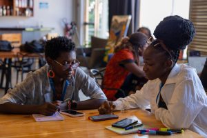 Two participants engaged in a discussion during a training session.