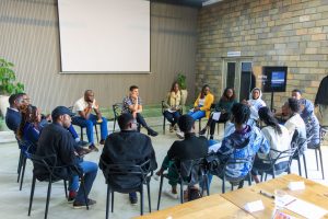 Participants seated in a circle during a group discussion at the training session.